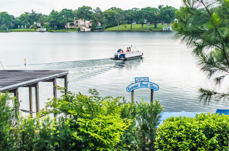 A boat depart from the dock on Lake Osceola.