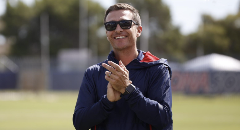 Tony Amato claps his hands from the sidelines of the soccer field.