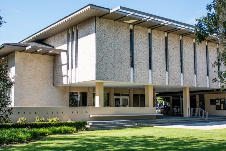 Beige building with green grass and blue sky