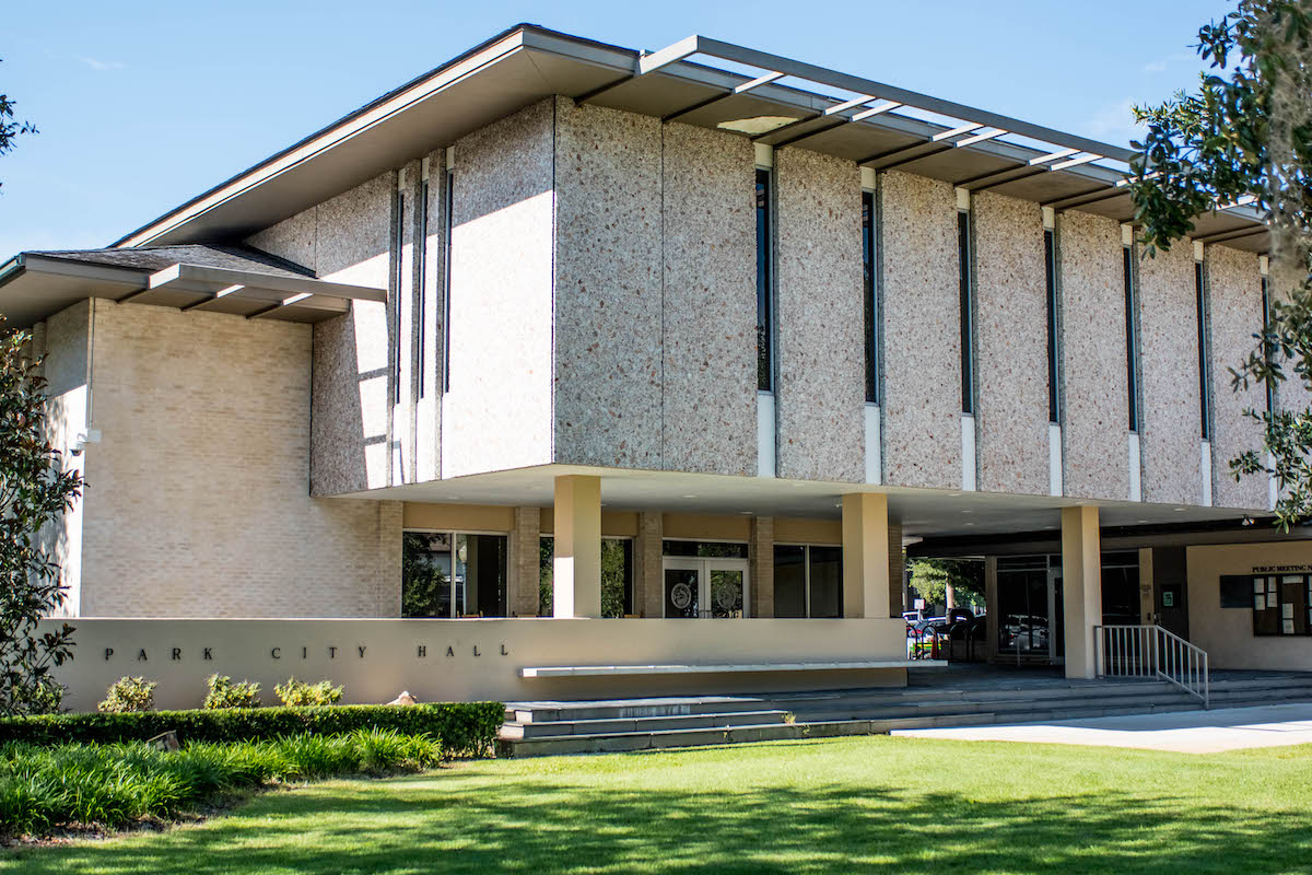 Beige building with green grass and blue sky