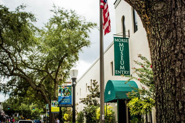 white building, American flag, and green Morse Museum sign