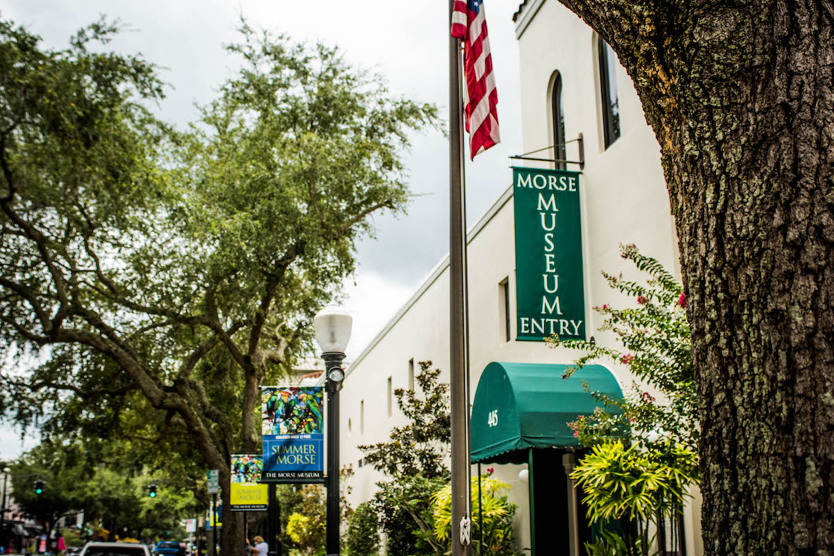 white building, American flag, and green Morse Museum sign